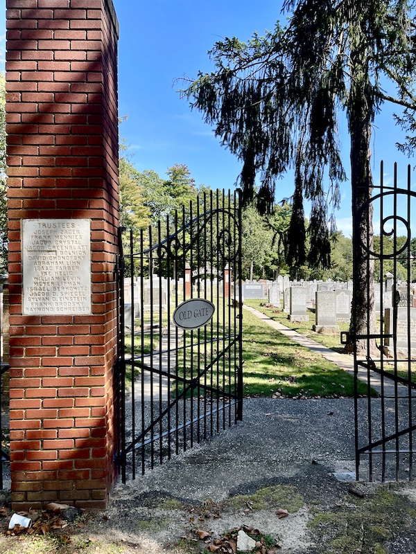 Red brick pillar and open black wrought iron gate at Alliance Synagogue and Cemetery Pittsgrove NJ