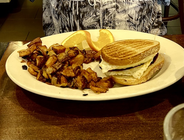 Breakfast sandwich on rye toast with home fries at Johnny's Café Margate NJ