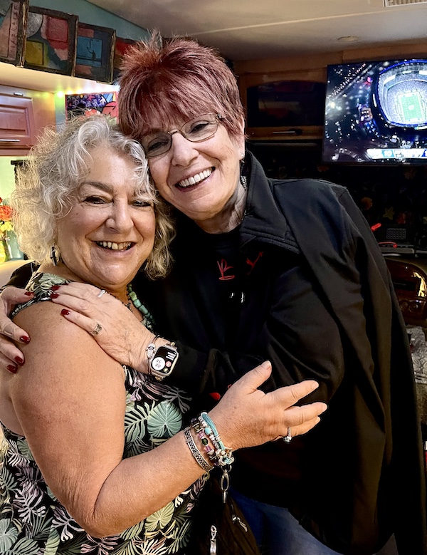 Me in a print dress and a woman with short red hair and glasses in black on our RV before our brunch at Johnny's Café Margate NJ