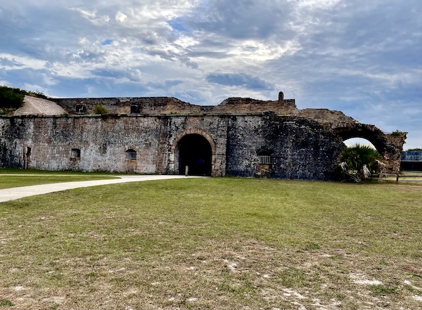 Brick fortress that is eroding with green lawn in foreground at Fort Pickens Pensacola Florida