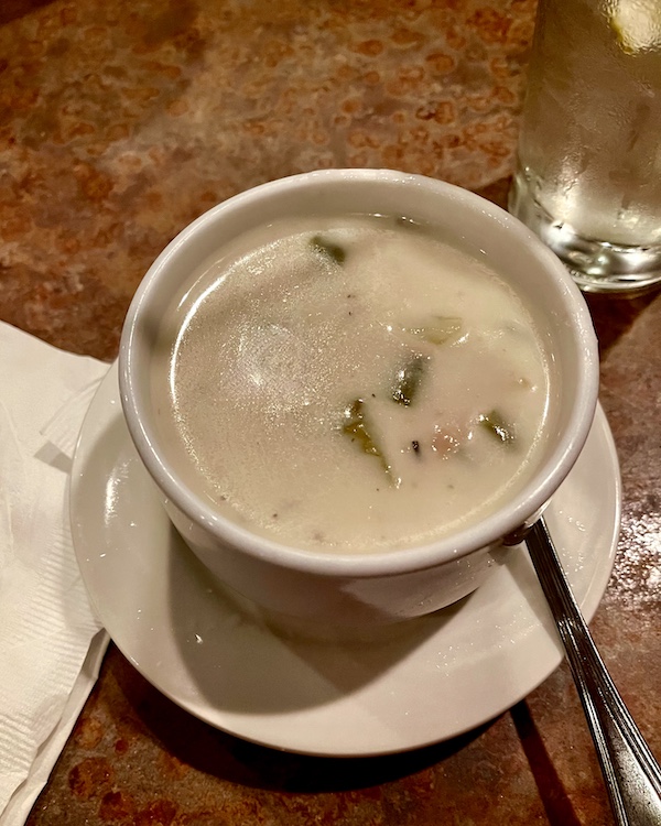 Cup of white clam chowder on a saucer with a spoon was part of October Fun at Jersey Shore