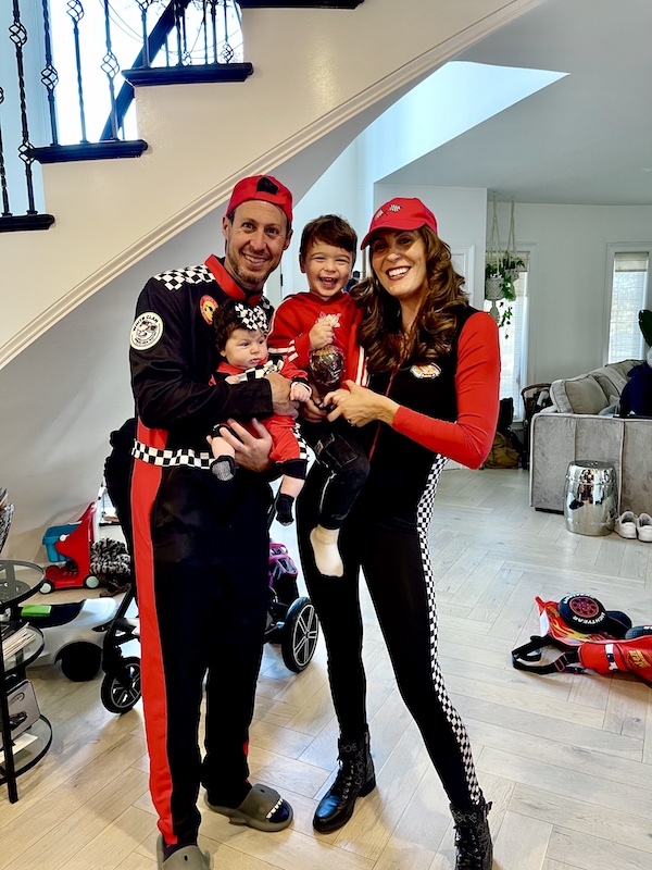 A young couple and their two children all dressed in car racing attire for October Fun at Jersey Shore