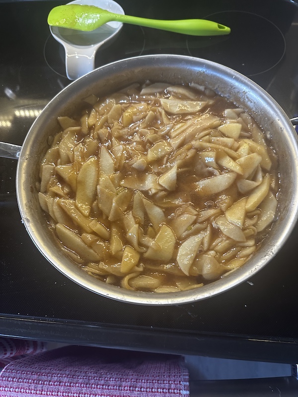 A skillet filled with cooked apple slices with cinnamon spiced juices for our Thanksgiving in March?