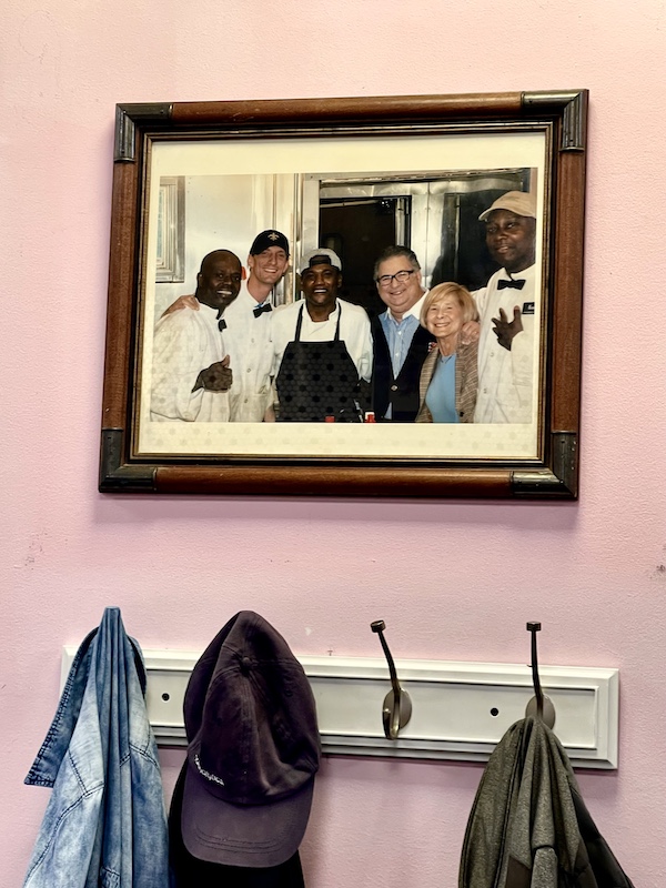 Framed photo on the wall of Camellia Grill New Orleans showing the owners and staff.