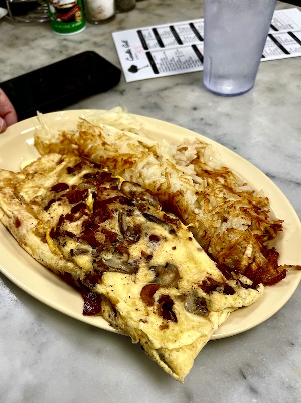 Bacon, mushroom and cheese omelette with crispy hash browns at Camellia Grill New Orleans