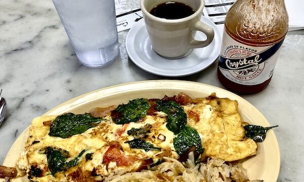 Omelette of tomato, spinach, onion and feta served with hash browns at Camellia Grill New Orleans