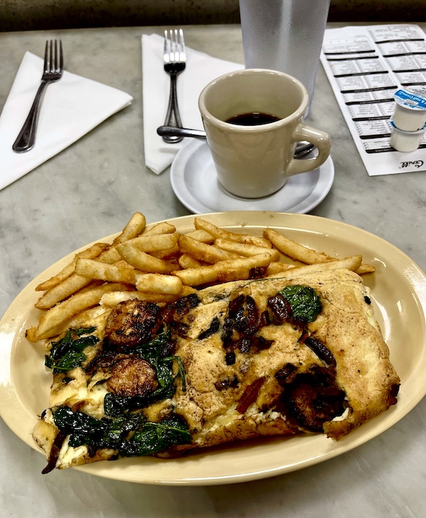 Shrimp, feta, spinach and onion omelette with hash browns at Camellia Grill New Orleans
