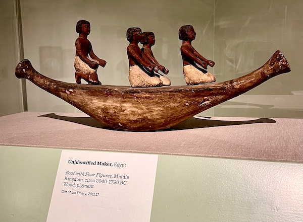 Wood carving of an ancient boat with 4 Egyptian figures at New Orleans Museum of Art