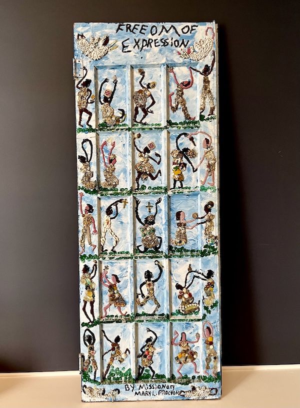 Wood door painted to depict dancing figures on display at New Orleans Museum of Art