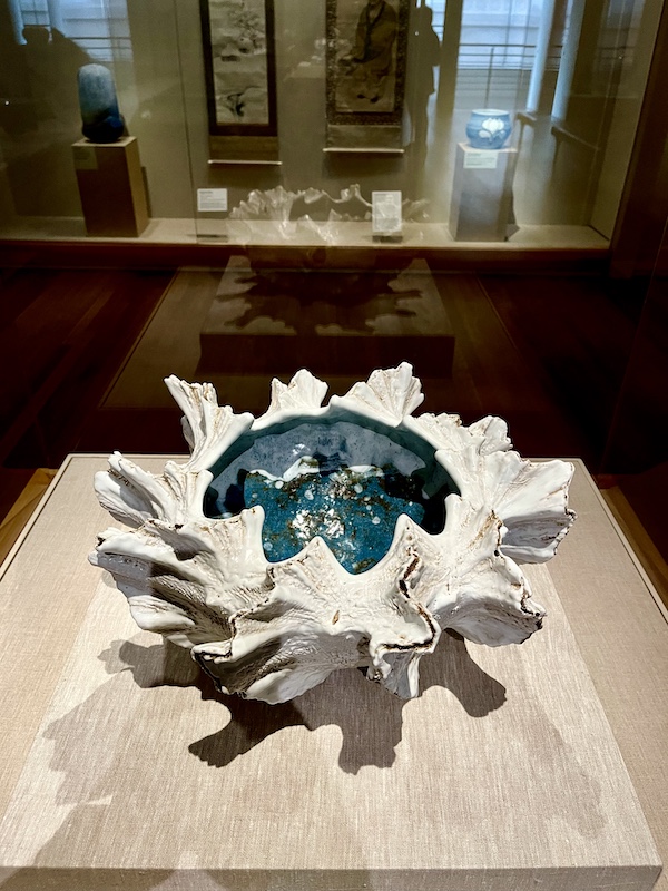 White and ocean blue irregularly shaped shallow vase on display at the New Orleans Museum of Art
