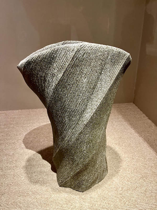 Gray/green textural stoneware vase with a pleated appearance at the New Orleans Museum of Art