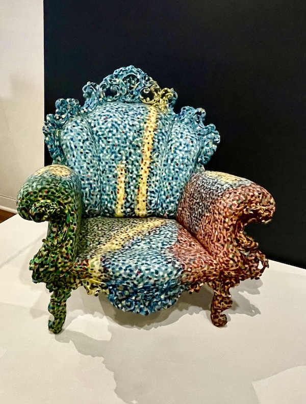 Colorful armchair with curving lines and wood frame on display at New Orleans Museum of Art Part 2