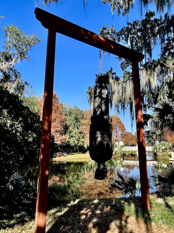 Bronze of a salesman hanging by his feet seen while Sharing Sculpture Garden with Friends