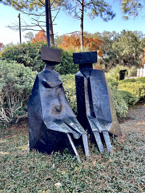 Bronze stature of 2 figures that look like they are made from giant railroad spikes. Photo taken while Sharing Sculpture Garden with Friends