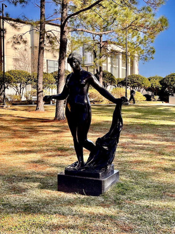 Statue of Venus holding a golden apple on the lawn of the sculpture garden.