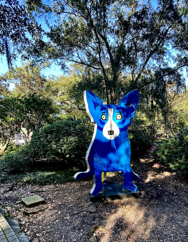 Three sided sculpture of a dog, one side is blue dog, next is red dog and third is yellow dog. Photos taken while We Stand Together, Blue Dog Side, 2005, Steel, aluminum, chrome and acrylic paint by George Rodrigue, American