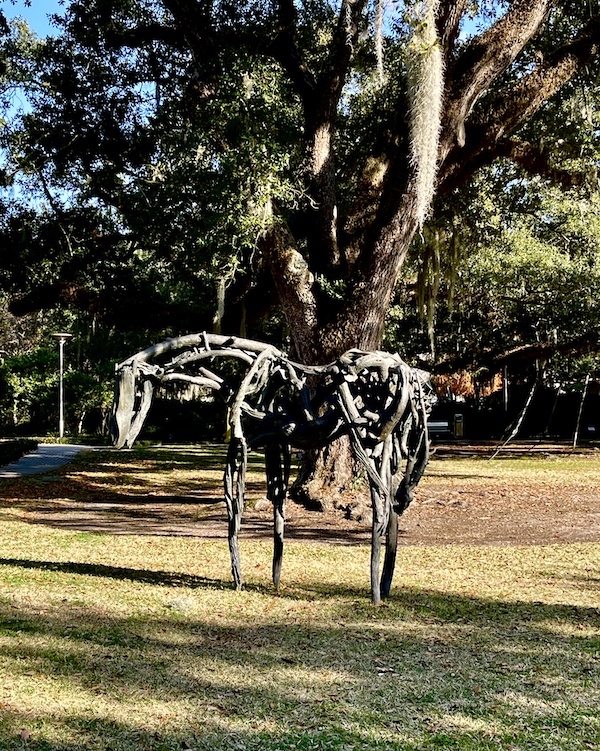 Stylized bronze statue of a horse with sunlight shining on it seen while Sharing Sculpture Garden with Friends