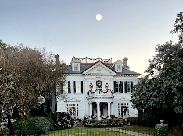 Large white home with columns and landscaping viewed on our way to The Columns New Orleans
