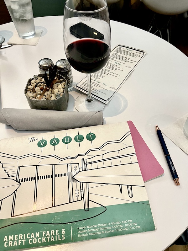 White, black and green menu on the table at The Vault Tulsa Oklahoma