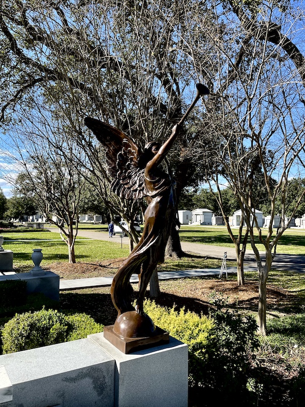 Bronze statue of a herald angel at the gardens of Historic Metairie Cemetery Louisiana
