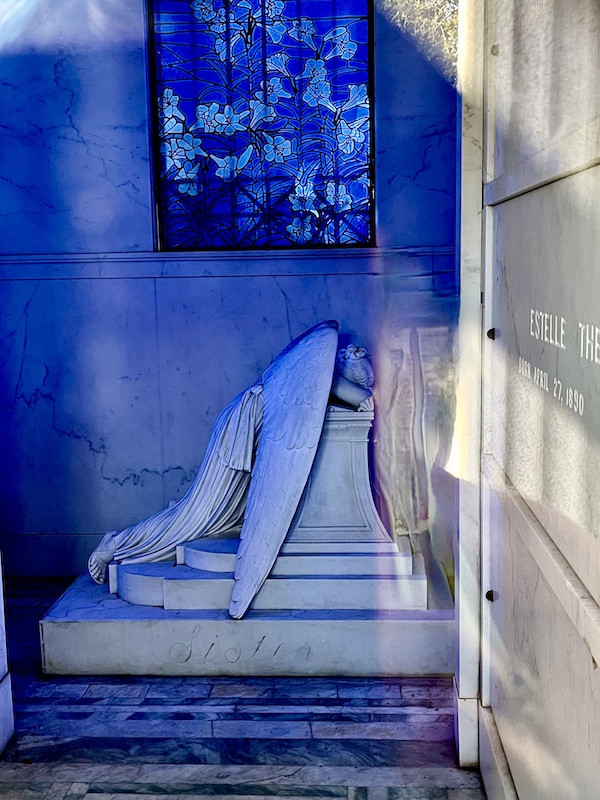 Statue of a weeping angel inside a mausoleum at Historic Metairie Cemetery Louisiana