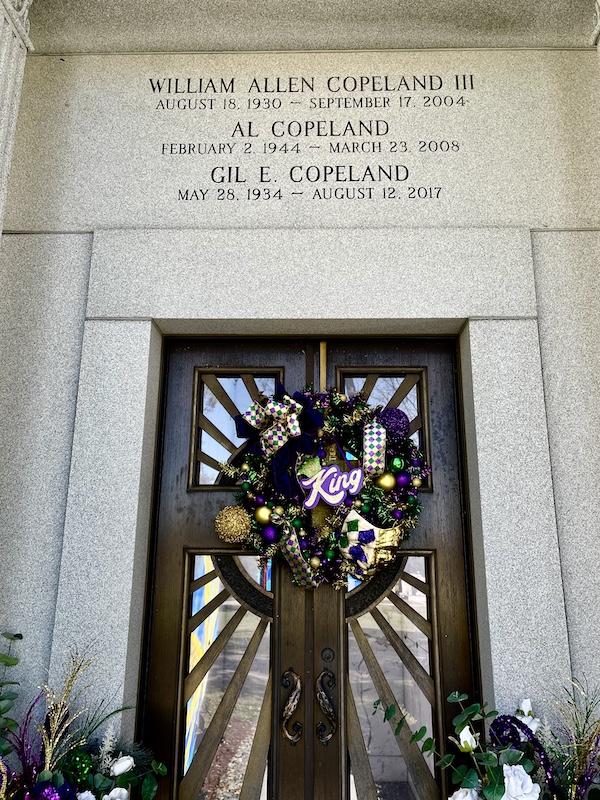 Mausoleum decorated in purple, green and gold for Mardi Gras at Historic Metairie Cemetery Louisiana