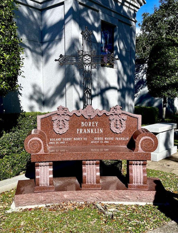 Red marble bench at Historic Metairie Cemetery Louisiana is a family memorial.