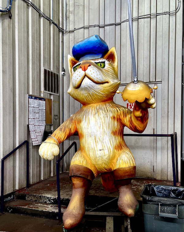 Cat float statue with blue cap and sword at Mardi Gras World NOLA
