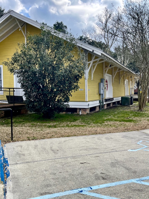 Yellow siding on building that houses the Louisiana Orphan Train Museum at Le Vieux Village Opelousas LA