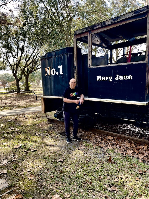 Steve leaning against an old train car at Le Vieux Village Opelousas LA
