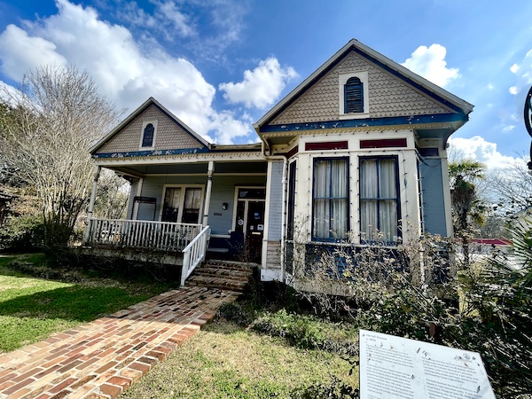 Gray house with white and burgundy trim at Le Vieux Village Opelousas LA