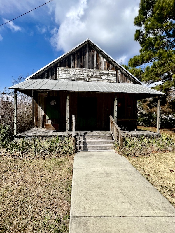 Old brown building with covered porch was the old general store in Le Vieux Village Opelousas LA