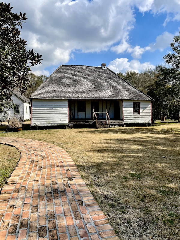 White siding house with mansard roof at Le Vieux Village Opelousas LA