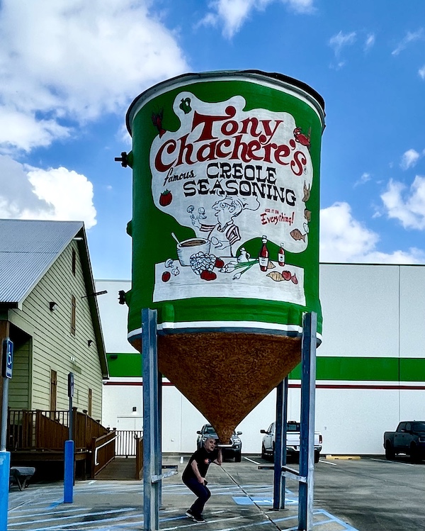 Steve with his head under a silo so it looks like the sTony Chachere's Famous Creole Seasoning inside will pour right into his mouth.