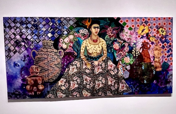 Three canvasses depicting Frida Kahlo in a colorful floral dress. Part of the Frida Kahlo Exhibit Houston