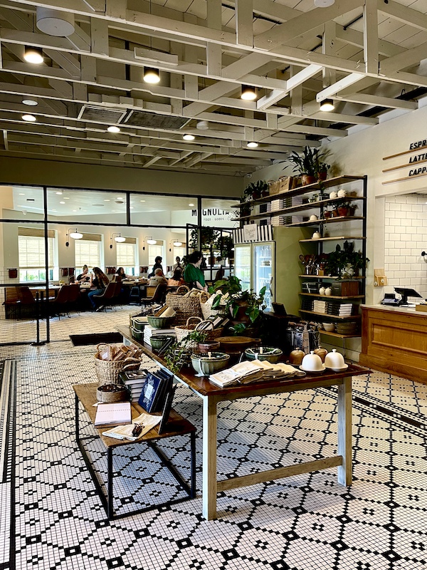 A display of bowls and books with a view of the Magnolia Table Waco Texas dining room