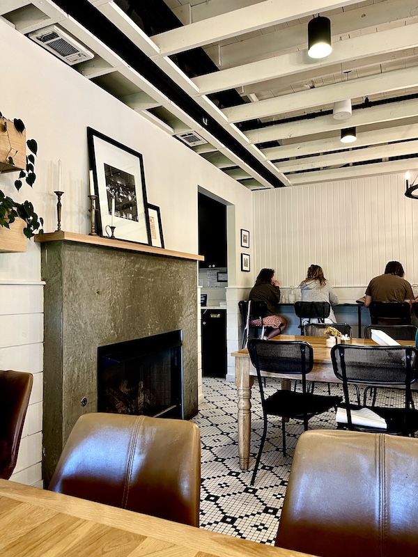Tiled floors, tables, chairs and fireplace at Magnolia Table Waco Texas