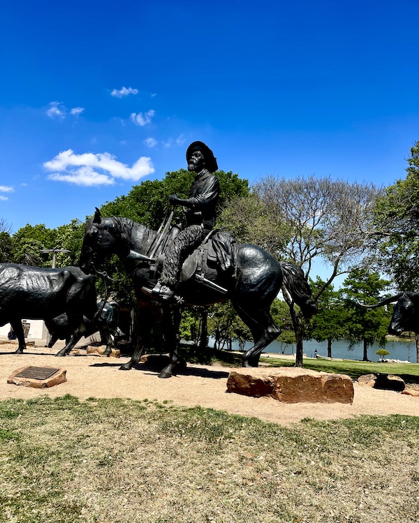 Bronze sculpture of a cowboy on a horse by the Brazos River in Waco Texas