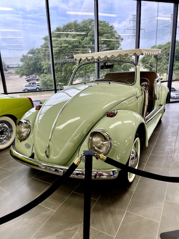 Mint green Volkswagen Beetle with striped awning roof at DFW Car and Toy Museum