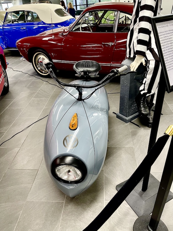 A VW mini bike motorcycle in light gray at DFW Car and Toy Museum