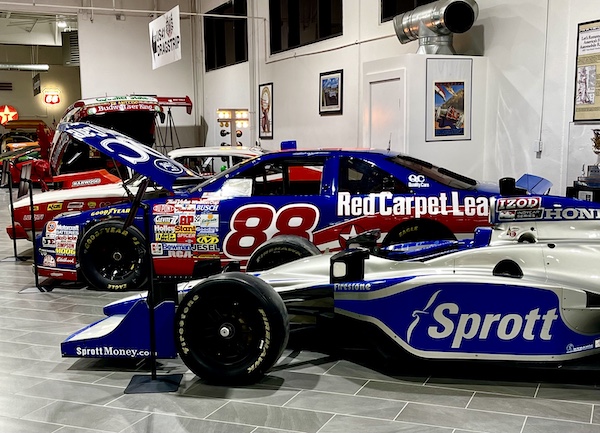 Red white and blue racing cars on display at DFW Car and Toy Museum