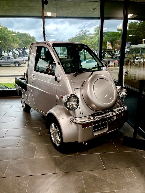 Silver tiny pickup truck on display at DFW Car and Toy Museum
