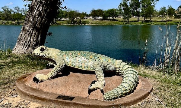 Concrete and steel sculpture of an ornate spiny lizard at Indian Springs Park Waco Texas