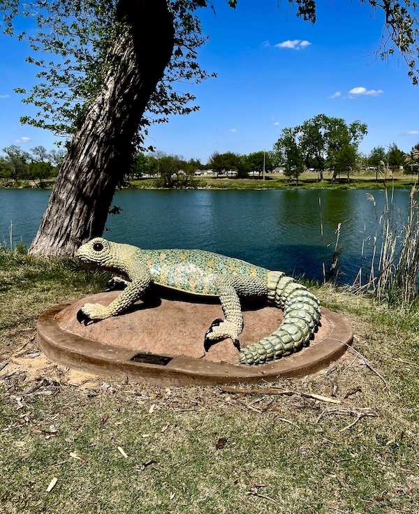 Concrete and steel sculpture of an ornate spiny lizard at Indian Springs Park Waco Texas