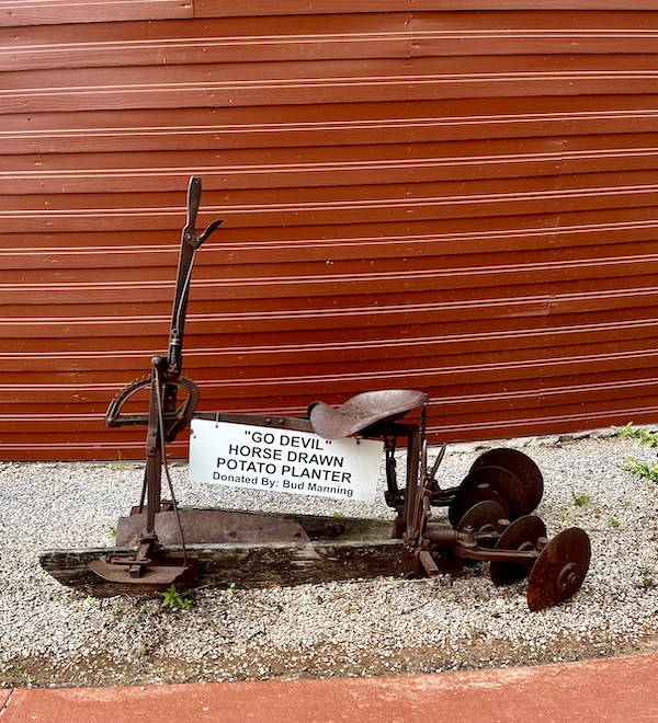 Antique potato planter in the gravel surrounding the Arcadia Round Barn Oklahoma