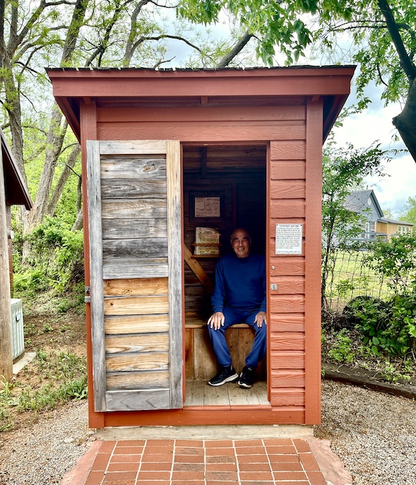 Steve pretending to be using the outhouse at Arcadia Round Barn Oklahoma