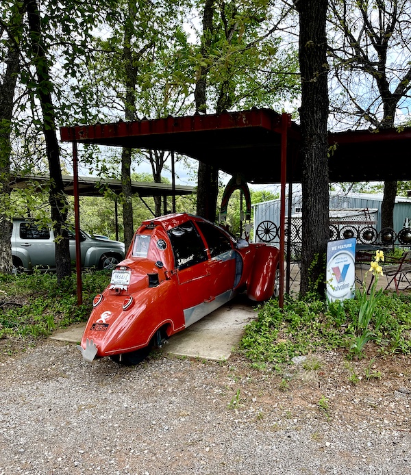 Odd red vehicle under a car port at John's Place Arcadia Oklahoma