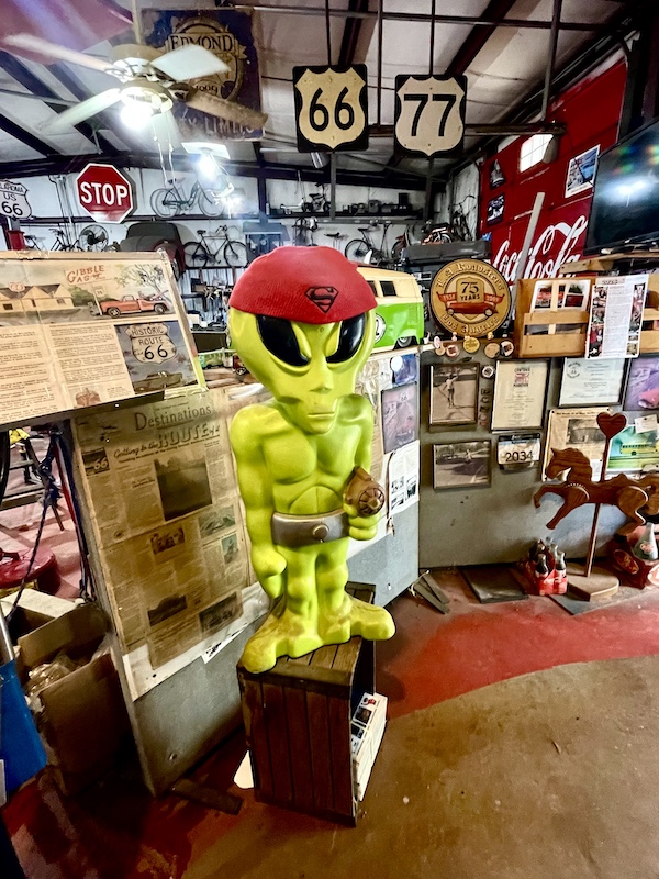 Neon green man with red cap inside John's Place Arcadia Oklahoma
