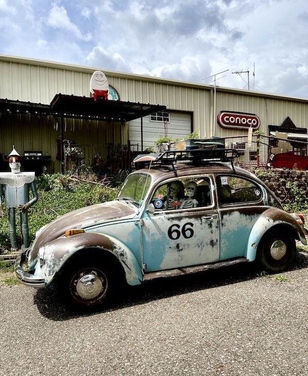 Old aqua VW Beetle parked outside a building at John's Place Arcadia Oklahoma