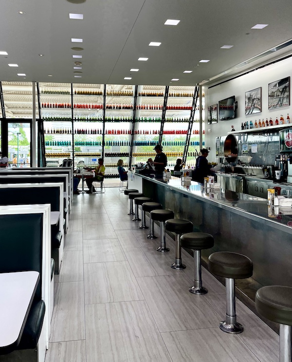 Diner counter with stools and wall of sodas at Pops Route 66 Arcadia Oklahoma